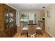 Bright dining room with glass-top table, wicker chairs, and pool view at 12709 Clock Tower Pkwy, Hudson, FL 34667