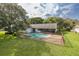 Home with fenced-in pool and lush lawn at 12709 Clock Tower Pkwy, Hudson, FL 34667