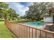 Relaxing pool area with fenced yard and lush landscaping at 12709 Clock Tower Pkwy, Hudson, FL 34667