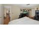 Main bedroom with a king-size bed and views of the living room at 12709 Clock Tower Pkwy, Hudson, FL 34667