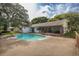 Inviting kidney-shaped pool with screened patio and fenced backyard at 12709 Clock Tower Pkwy, Hudson, FL 34667