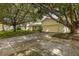 Single-story home with large driveway and mature trees at 12709 Clock Tower Pkwy, Hudson, FL 34667