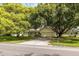 Single-story home with mature trees and street view at 12709 Clock Tower Pkwy, Hudson, FL 34667