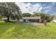 Home with fenced-in pool and lush lawn at 12709 Clock Tower Pkwy, Hudson, FL 34667