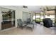 Relaxing screened porch with patio furniture and grill overlooking the pool at 12709 Clock Tower Pkwy, Hudson, FL 34667