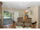 Dining area with a view of the kitchen and backyard pool at 12709 Clock Tower Pkwy, Hudson, FL 34667