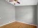 Simple bedroom with gray walls, wood floors, and ceiling fan at 612 N Lake Blvd, Tarpon Springs, FL 34689