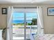 Bedroom with water view through sliding glass doors at 6530 Driftwood Dr, Hudson, FL 34667