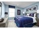 Blue themed bedroom with a full-size bed and Star Wars decor at 8731 Starry Night Ter, Parrish, FL 34219