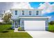 Two-story house with light blue vinyl siding, white trim, and a two-car garage at 8731 Starry Night Ter, Parrish, FL 34219