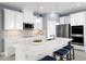 Modern kitchen with white cabinets, stainless steel appliances, and a large island at 8731 Starry Night Ter, Parrish, FL 34219