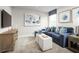 Comfortable living room with blue sectional sofa and ottomans at 8731 Starry Night Ter, Parrish, FL 34219
