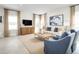 Living room with beige rug, comfy seating, and large windows offering natural light at 8731 Starry Night Ter, Parrish, FL 34219