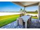 Relaxing patio with table and chairs, overlooking backyard at 8731 Starry Night Ter, Parrish, FL 34219