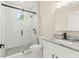 Modern bathroom featuring white cabinets, granite countertop, and a walk-in shower with black hardware at 9229 Creston Ave, New Port Richey, FL 34654