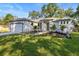 Beautifully landscaped home with modern design, featuring a well-manicured lawn and fresh curb appeal at 9229 Creston Ave, New Port Richey, FL 34654