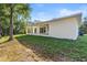 Modern home exterior featuring a covered patio, and a well-maintained lawn at 9229 Creston Ave, New Port Richey, FL 34654