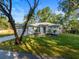 Charming single-story home with manicured lawn and mature trees providing shade at 9229 Creston Ave, New Port Richey, FL 34654