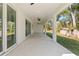 Spacious covered patio with ceiling fans, offering an outdoor living space with backyard views at 9229 Creston Ave, New Port Richey, FL 34654