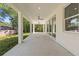 Covered patio with ceiling fans providing a relaxing outdoor space, bright and spacious at 9229 Creston Ave, New Port Richey, FL 34654