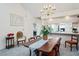 Bright dining room with a wooden table, chandelier, and kitchen views at 3275 Lori Ln # 5, New Port Richey, FL 34655