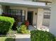 Front entry of a villa with landscaping and a paved walkway at 3275 Lori Ln # 5, New Port Richey, FL 34655