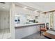 Kitchen features white cabinets and a pass-through to the dining area at 3275 Lori Ln # 5, New Port Richey, FL 34655
