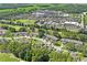 Aerial view of a community with houses and a hospital in the background at 3275 Lori Ln # 5, New Port Richey, FL 34655