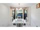 Charming dining area with a white table and gray chairs, offering a view of the backyard at 3275 Lori Ln # 5, New Port Richey, FL 34655