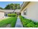 Side view of a villa with lush landscaping and walkway at 3275 Lori Ln # 5, New Port Richey, FL 34655