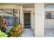 Front entry of a villa with landscaping and a paved walkway at 3275 Lori Ln # 5, New Port Richey, FL 34655