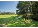 Serene backyard view, lush grass, pond, and trees at 3275 Lori Ln # 5, New Port Richey, FL 34655