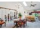 Spacious dining room with a wooden table, chandelier, and access to the living room at 3275 Lori Ln # 5, New Port Richey, FL 34655