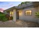 Inviting exterior featuring a brick walkway and lush landscaping at 3275 Lori Ln # 5, New Port Richey, FL 34655