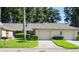 Front view of a charming villa with a well-maintained lawn and two-car garage at 3275 Lori Ln # 5, New Port Richey, FL 34655
