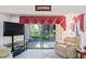 Relaxing living room with large TV and view of the screened patio at 3275 Lori Ln # 5, New Port Richey, FL 34655
