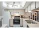 Kitchen with white cabinets, a double sink, and a view to the living room at 3275 Lori Ln # 5, New Port Richey, FL 34655