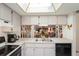 Kitchen features white cabinets, black appliances, and a breakfast bar at 3275 Lori Ln # 5, New Port Richey, FL 34655
