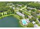 Aerial view of community with lake, pool, and building at 3232 Lake Pine E Way # H2, Tarpon Springs, FL 34688