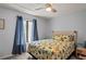 Comfortable bedroom with a ceiling fan and nautical bedding at 3232 Lake Pine E Way # H2, Tarpon Springs, FL 34688