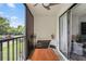 Spacious screened lanai with table, chairs, and views of lush landscaping at 3232 Lake Pine E Way # H2, Tarpon Springs, FL 34688
