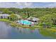 Aerial view of community pool and lakefront at 3232 Lake Pine E Way # H2, Tarpon Springs, FL 34688