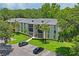 Attractive building exterior with ample parking and landscaping at 3232 Lake Pine E Way # H2, Tarpon Springs, FL 34688