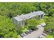 Condo building showcasing its architecture and green surroundings at 3232 Lake Pine E Way # H2, Tarpon Springs, FL 34688