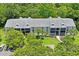 Condo complex with tree-lined landscape and parking at 3232 Lake Pine E Way # H2, Tarpon Springs, FL 34688