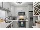 Modern kitchen with stainless steel appliances and white cabinets at 3232 Lake Pine E Way # H2, Tarpon Springs, FL 34688