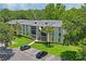 Two-story condo building with ample parking and lush landscaping at 3232 Lake Pine E Way # H2, Tarpon Springs, FL 34688