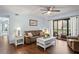 Cozy living room featuring a brown leather sofa and access to a balcony at 3232 Lake Pine E Way # H2, Tarpon Springs, FL 34688