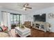 Living room with brown leather furniture, white coffee table, and sliding glass doors at 3232 Lake Pine E Way # H2, Tarpon Springs, FL 34688