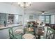 Light and airy dining area with glass-top table and seating for four at 3232 Lake Pine E Way # H2, Tarpon Springs, FL 34688